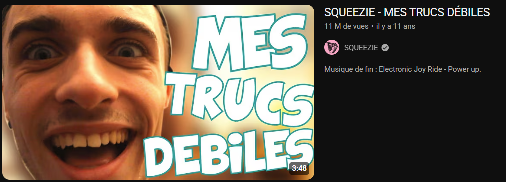 Capture d'écran d'une vidéo YouTube de Squeezie intitulée « MES TRUCS DÉBILES ». La miniature montre un gros plan du visage du vidéaste, qui sourit de manière exagérée avec les yeux grands ouverts, à côté du titre écrit en grosses lettres.
