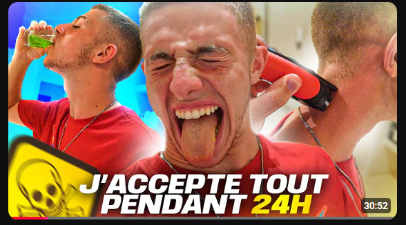 Miniature d'une vidéo de Michou qui pose dans trois situations différentes : buvant un liquide vert fluo, tirant la langue avec une expression de dégoût, et se faisant raser la nuque. Le texte « J'ACCEPTE TOUT PENDANT 24H » est écrit en gros caractères accompagné d'un logo de tête de mort.